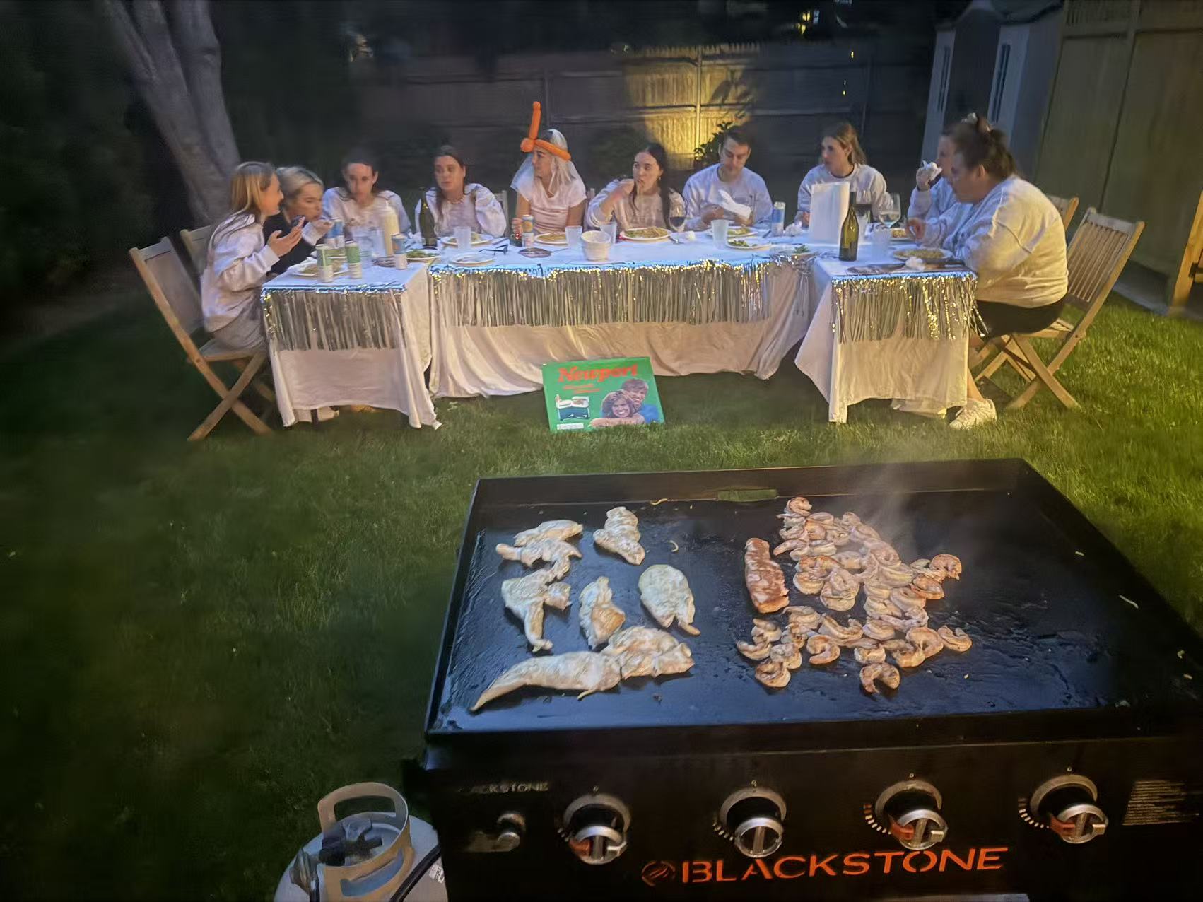 Shrimp and chicken grilling hibachi-style at a nighttime private party